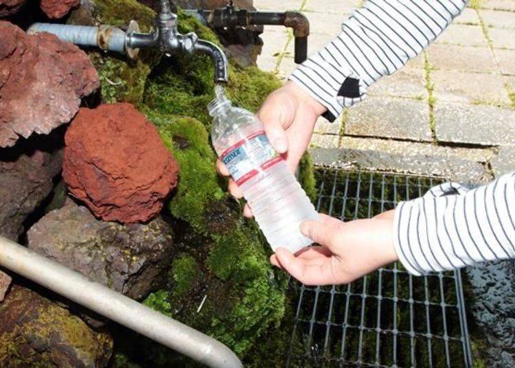 Refilling an empty palstic bottle. The water is rich in minerals.